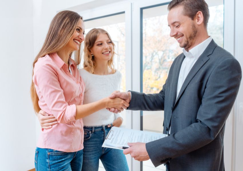 property-manager-handing-keys-to-couple
