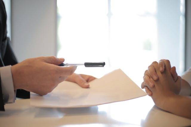 A person signing for a loan.