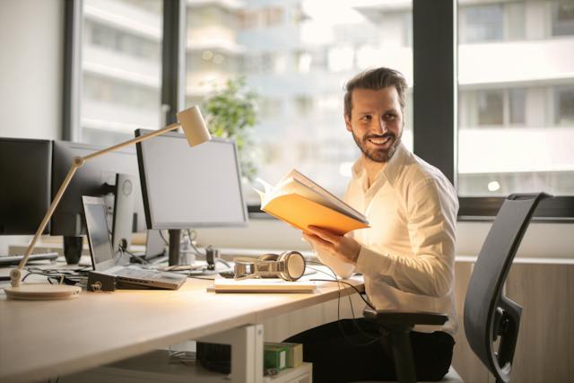 A happy businessman at a desk.
